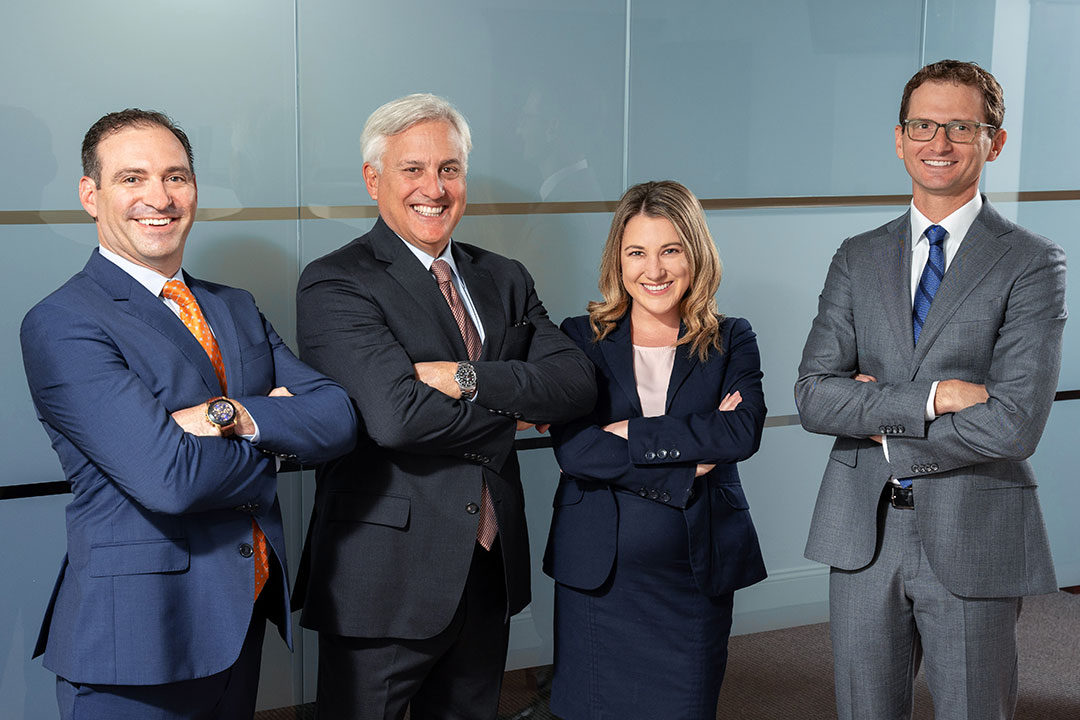 Group of personal injury experts from the MHM personal injury legal team with their arms crossed