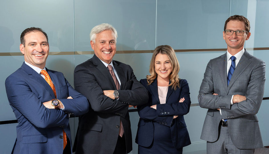 Group of personal injury experts from the MHM personal injury legal team with their arms crossed