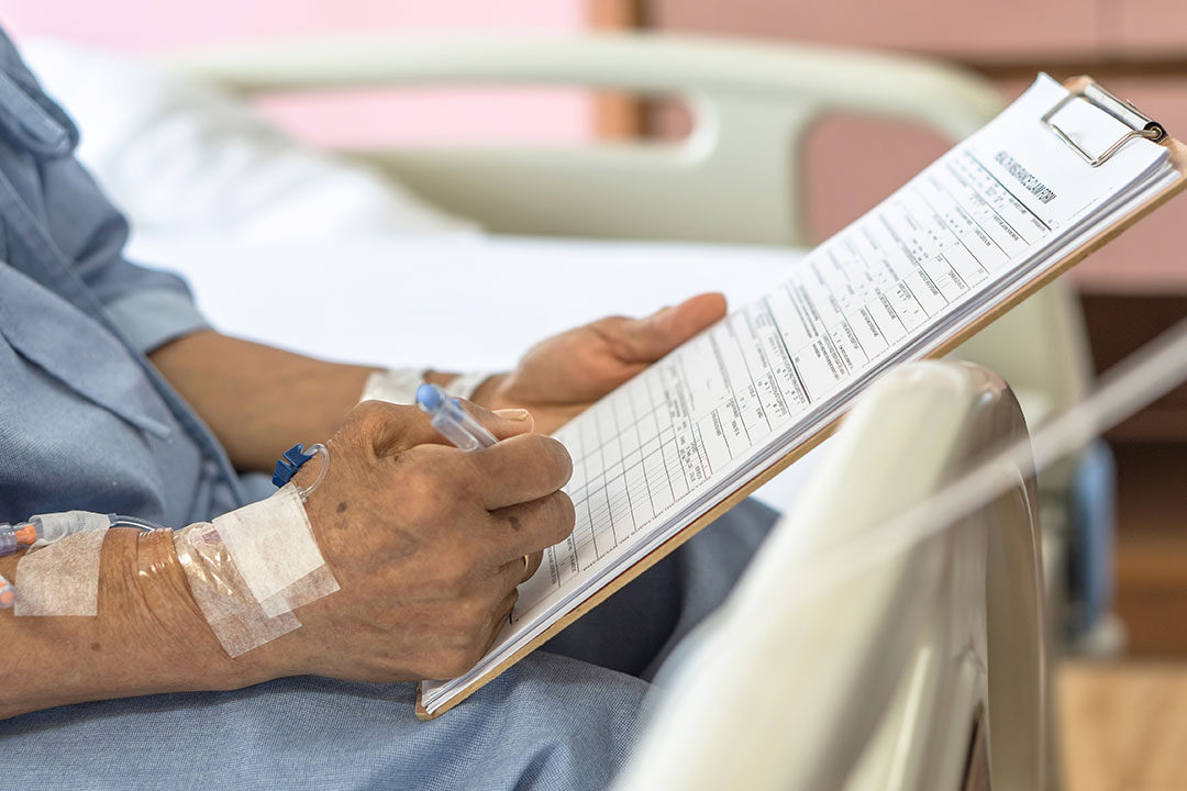 patient signining health insurance claim form in hospital
