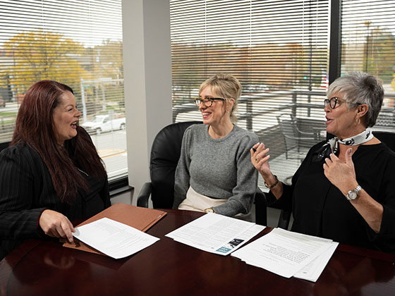 three female burn injury attorneys meeting in conference room