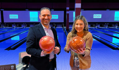 Josh Margolis and Joanna holding bowling balls at BackStoppers Bowling for Badges.