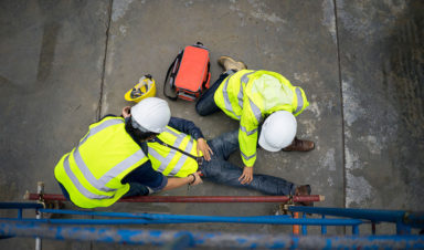 construction workers helping friend after lack of fall protection