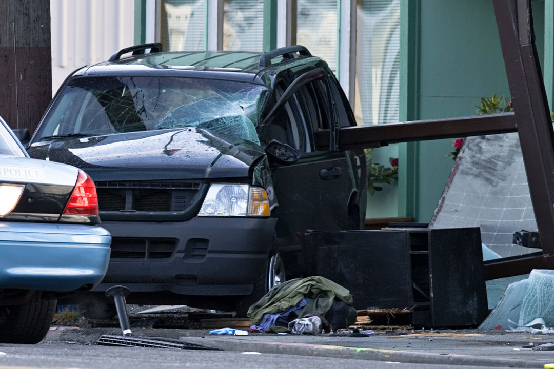A car crashes into a building, creating a risk of personal injury